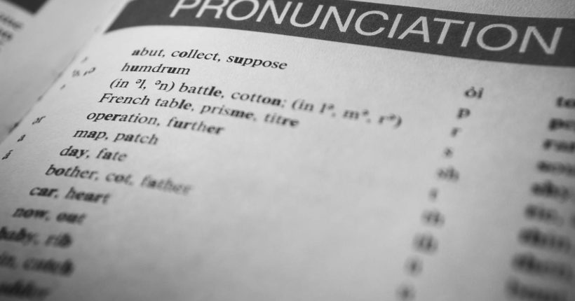 Photo by Nothing Ahead Black and white close-up of a dictionary page focused on pronunciation guides and phonetic symbols.