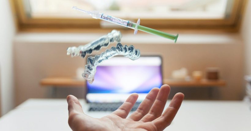 Photo by Daniel Frank open palm with syringe floating above