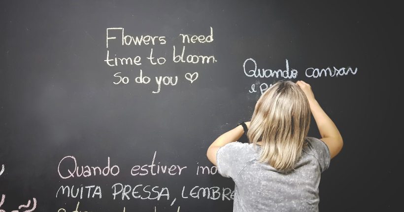 Photo by Leonardo Toshiro Okubo unknown person writing on chalkboard