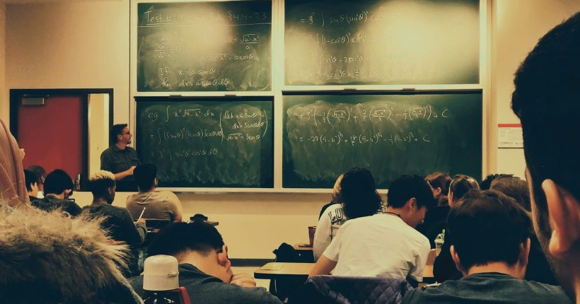 Photo by Shubham Sharan student sitting on chairs in front of chalkboard