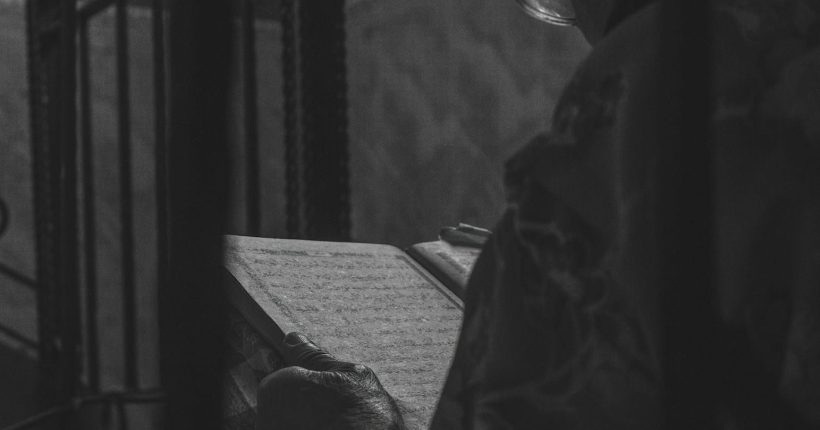 Photo by mohammed idris djoudi a black and white photo of a person reading a book