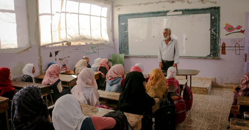 Photo by Ahmed akacha A classroom in Idlib, Syria, captures a teacher engaging students in a lively educational session.